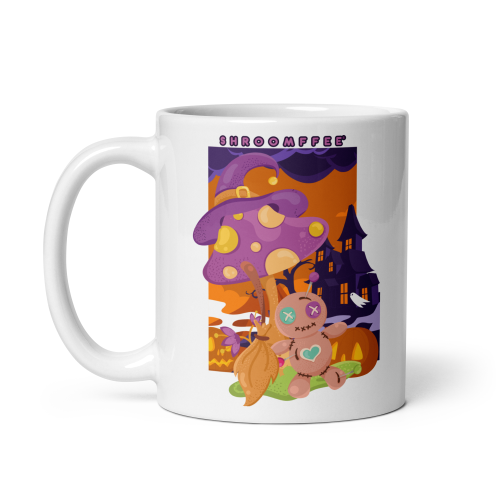 White mug with a colorful design featuring mushrooms and a house on a white background